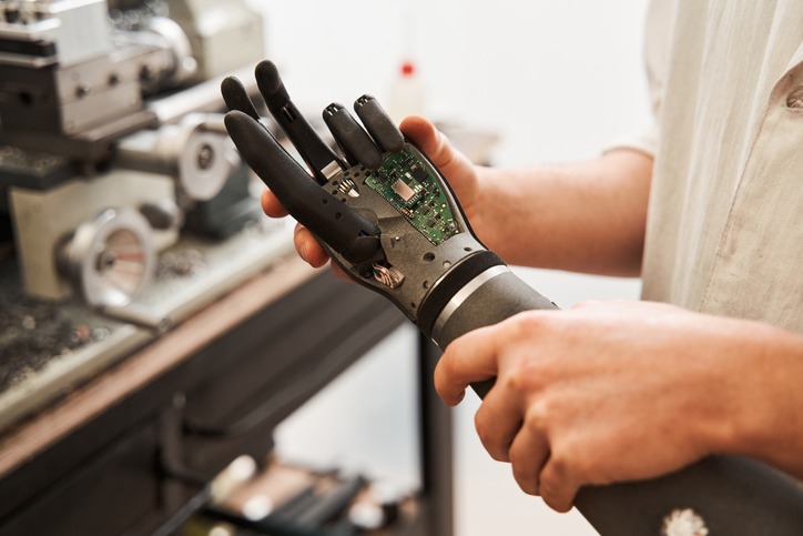Man holding bionic hand while developing prothesis 我哥的女人 limbs