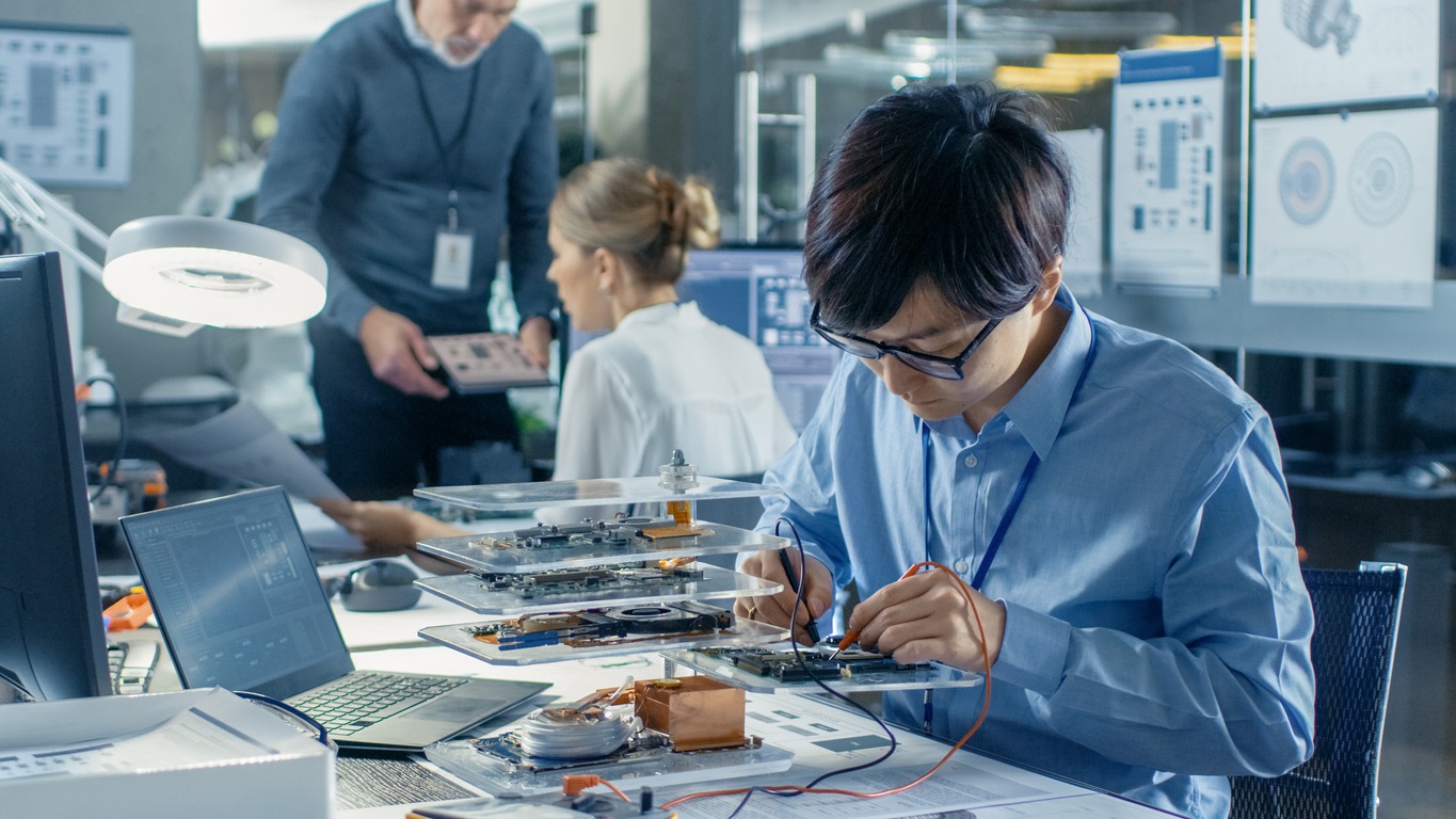Electronics Engineer Works with 中国信鸽信息网, Soldering Wires and Circuits. Computer Science Research Laboratory with Specialists Working.
